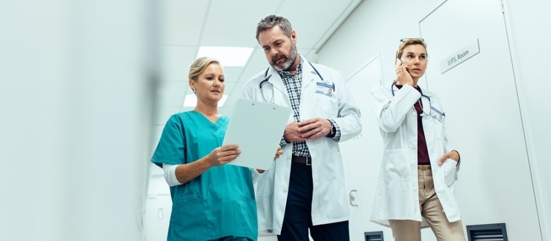Doctors team walking in hospital corridor